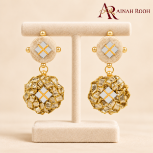 gold rosette earrings on ivory stand